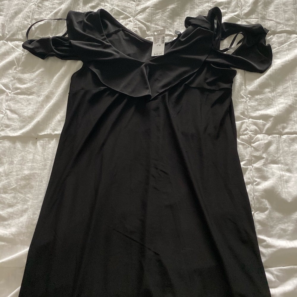 Women’s black dress with cut out sleeves.